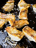 Fish fillets being fried
