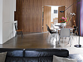 Dining area with wooden wall and modern design, accent with bouquet of flowers