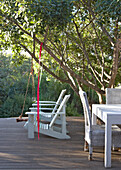 Wooden terrace with green furniture