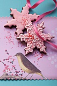 Star-shaped Christmas biscuits with pink icing