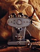 Espresso machine in front of jute sacks