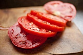 Tomato Sliced on a Wooden Cutting Board