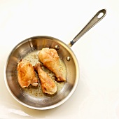 Pan Fried Chicken Thigh and Drumsticks; In Skillet; White Background