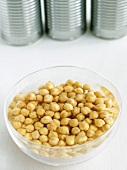 Bowl of Chickpeas Soaking in Water; Cans
