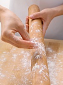 Dusting a rolling pin with flour