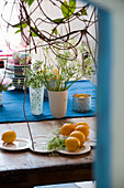 Table with blue table runner, lemons and flower vases