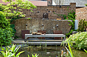 Asian-inspired garden with water basin and Buddha statue