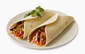 Two Beef Tacos in Flour Tortillas on a White Plate; White Background