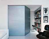 Side room of modern living room with open door and view of bookcase