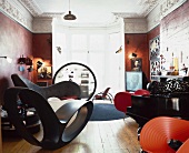 Designer seating and Bauhaus shelves in a luxurious room of a Baroque villa