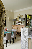 Dining room with marble counter, glass table and grey chairs