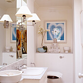 Brightly colored bathroom with marble washbasin and Buddha statue