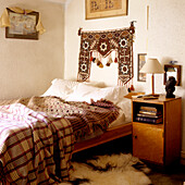 Bedroom with tapestry and patterned blankets