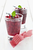 Cranberry dessert with vanilla pod and mint in dessert glass