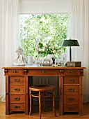 19th century oak desk and stool below window in study