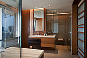 Modern bathroom with wooden elements and glass shower