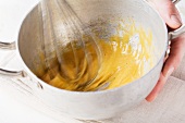 Whisking egg yolks with mustard