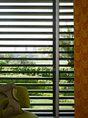 70s patterns in front of sun shade louver blinds with view of palm tree