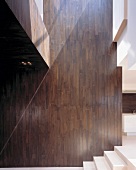 Double-height, wood-clad wall next to steps