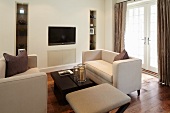 Cream upholstered furniture and brown coffee table in living room