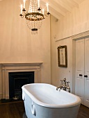 Traditional bathroom with fireplace and free-standing antique bathtub