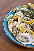 Oysters and lemons in a blue bowl