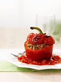 A pepper filled with lamb and bulgur wheat with tomato sauce