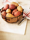 Various potatoes in a wire basket