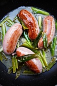 Sausages with spring onions