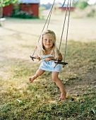 Little girl on a swing