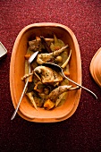 Rabbit with root vegetables in clay pot