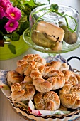 Plaited sesame rolls in front of cheese cover with blue cheese and pears