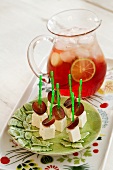 Feta and grape skewers and a jug of punch