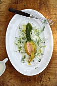 Stuffed courgette flowers with cucumber ribbons on yoghurt and dill sauce