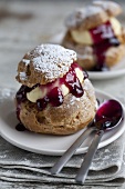 Profiteroles filled with vanilla cream and blueberry jam