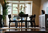 Dining area with black, antique wooden chairs
