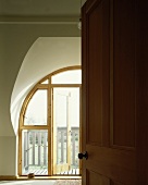 View of wooden balcony door through open door