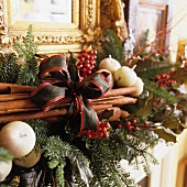 Christmas arrangement with cinnamon sticks and bow
