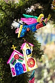 Colourful, sheet metal Christmas decorations on Christmas tree