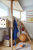 A wooden bunk bed in the corner of a child's bedroom