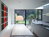 Kitchen with long, white dining table