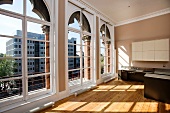 Spacious room with arched windows and kitchen island