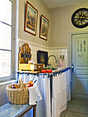 Country-style kitchen with cupboard curtains