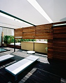 Modern terrace with relaxation area, shower and wheeled couches