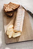 Sliced soft cheese with dark bread