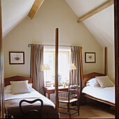 Attic bedroom with wooden beams and two single beds