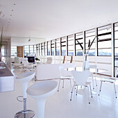 Bright living room with floor-to-ceiling windows and white furniture