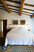 Bedroom with wooden beamed ceiling and carpet runners