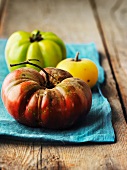 Heirloom tomatoes on a blue cloth