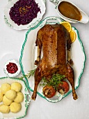 Roast goose with dumplings, red cabbage and orange sauce